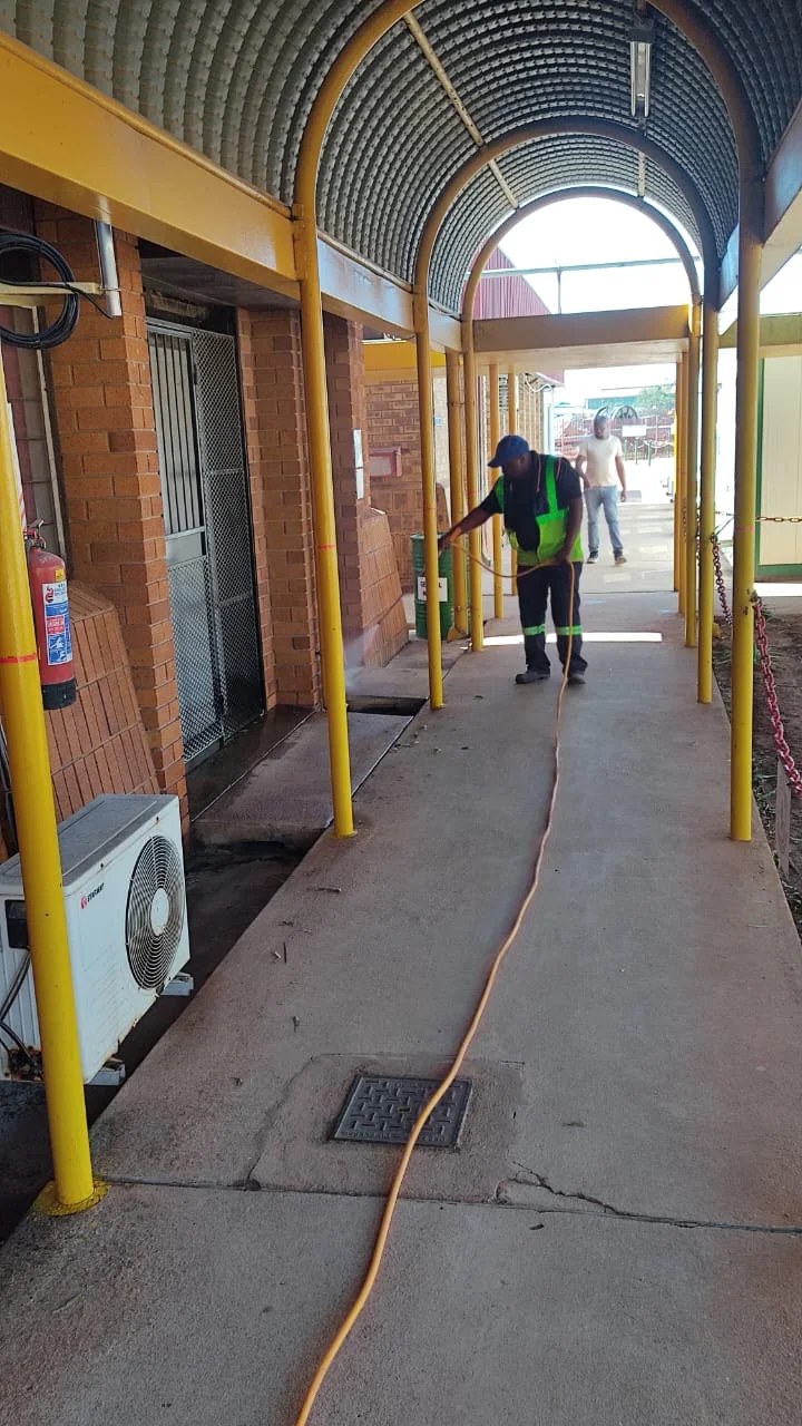 Technician treating a commercial property breezeway